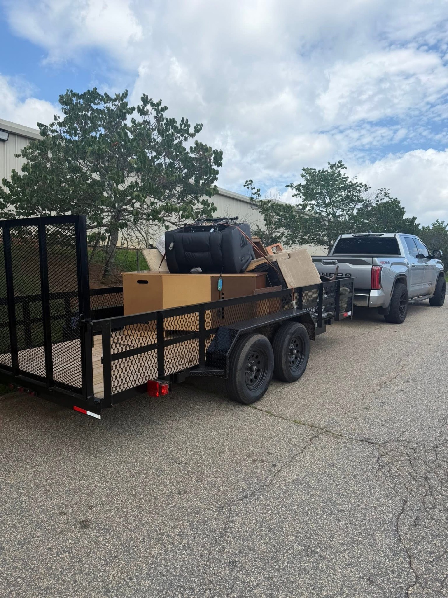 Truck and trailer loaded with old furniture for a Spartanburg cleanout